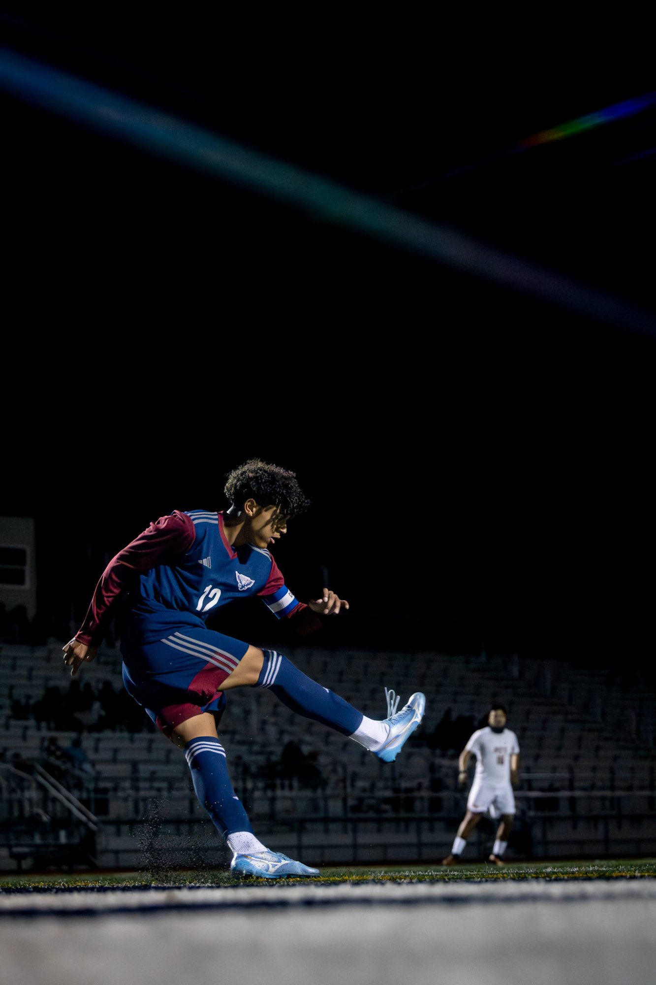 Soccer player kicking night game