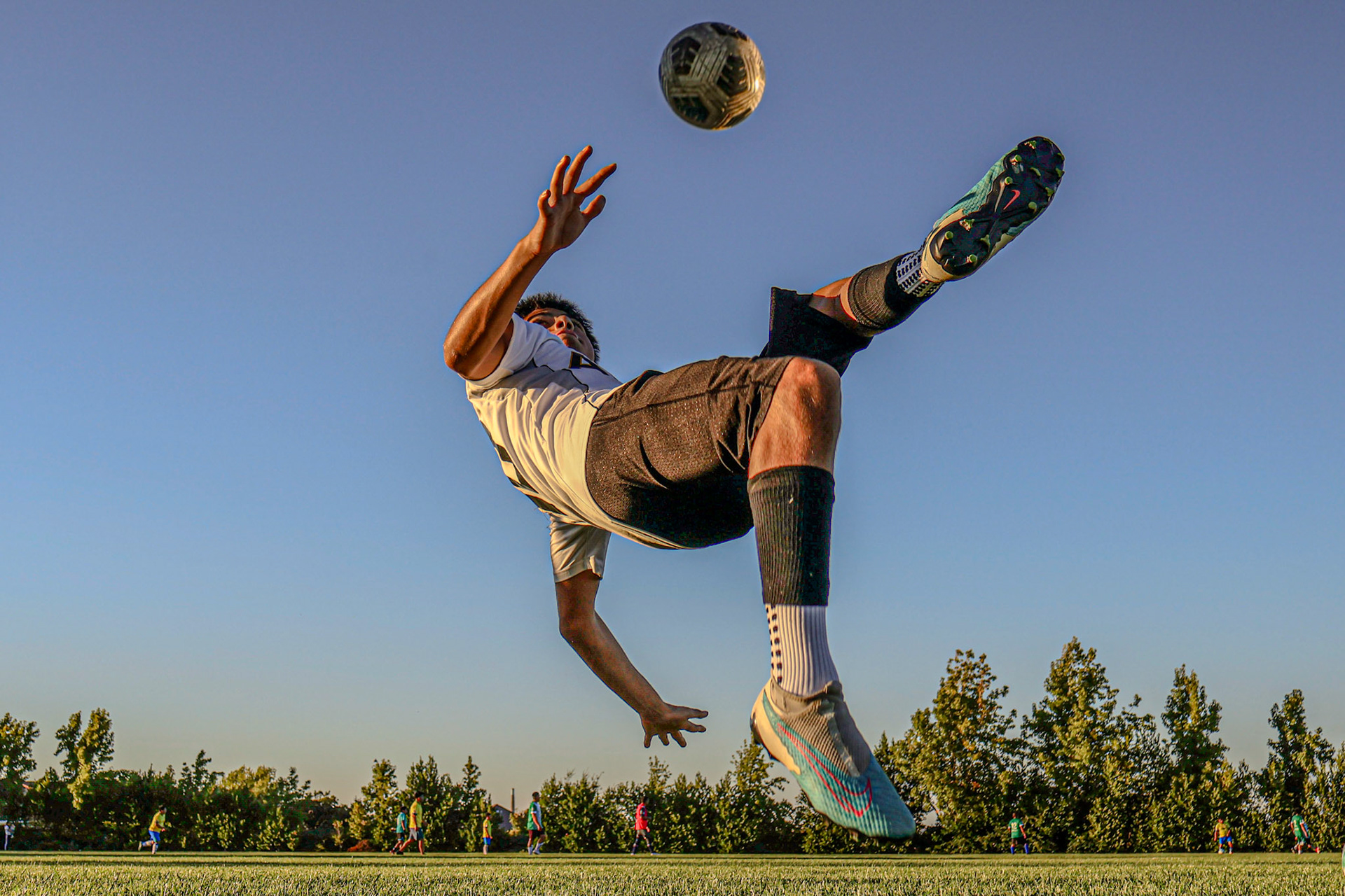 Soccer bicycle kick sunset